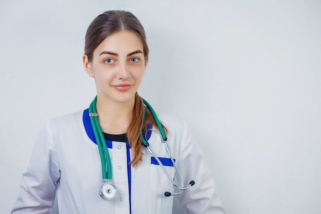 Portrait of an attractive young female doctor in white coat. 