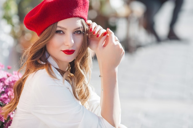 Portrait of attractive young girl outdoors. beautiful urban lady looking at camera. female with red lips.