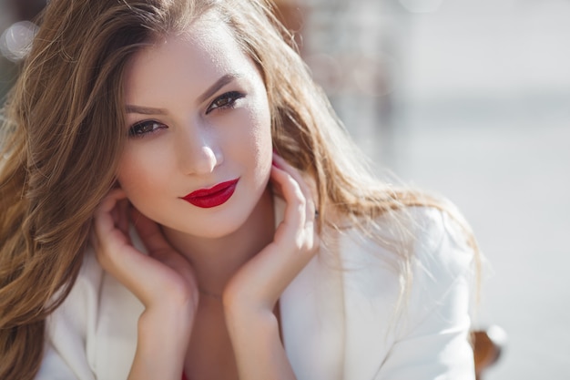 Portrait of attractive young girl outdoors. Beautiful urban lady lookingg at camera.