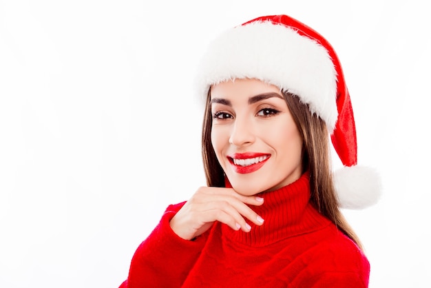 Portrait of attractive young happy woman wearing santa hat