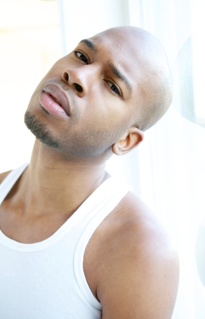 Portrait of an attractive young man relaxing by window