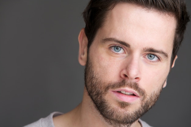 Portrait of an attractive young man with blue eyes and beard