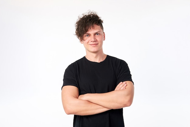 Portrait of attractive young stylish cheerful man wearing a black cotton T-shirt posing