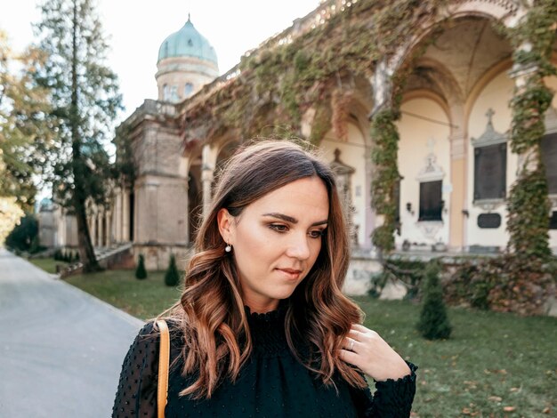 Portrait of attractive young woman in black dress beautiful dress pretty girl