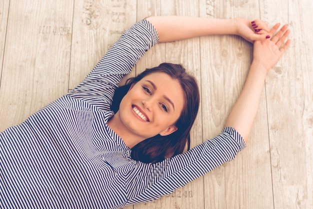 Portrait of attractive young woman is looking at camera.