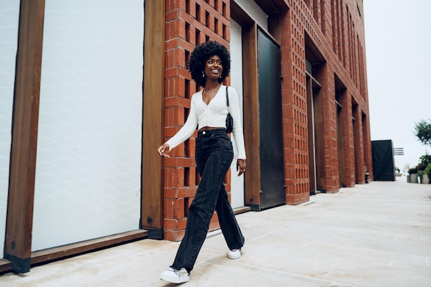 Portrait of attractive young woman walking outside in the city