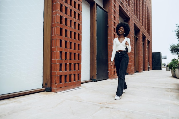 Portrait of attractive young woman walking outside in the city