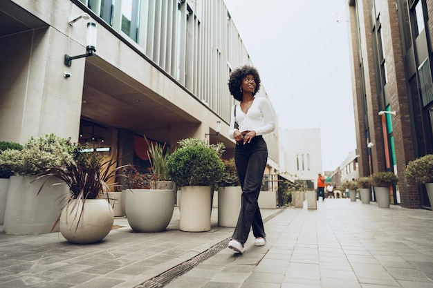 Portrait of attractive young woman walking outside in the city