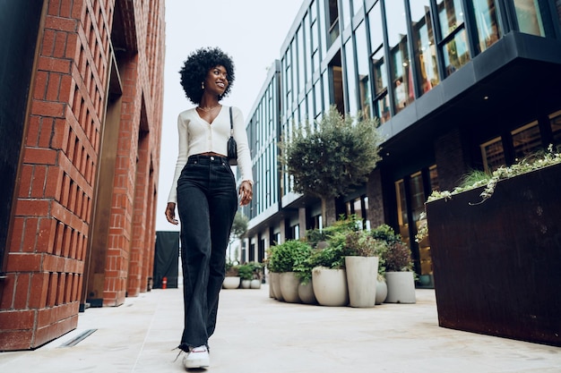 Portrait of attractive young woman walking outside in the city