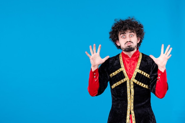 Portrait of azeri man in traditional costume studio shot blue background novruz ethnic dancer