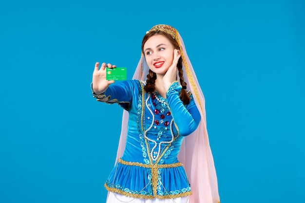 portrait of azeri woman in traditional dress holding credit card