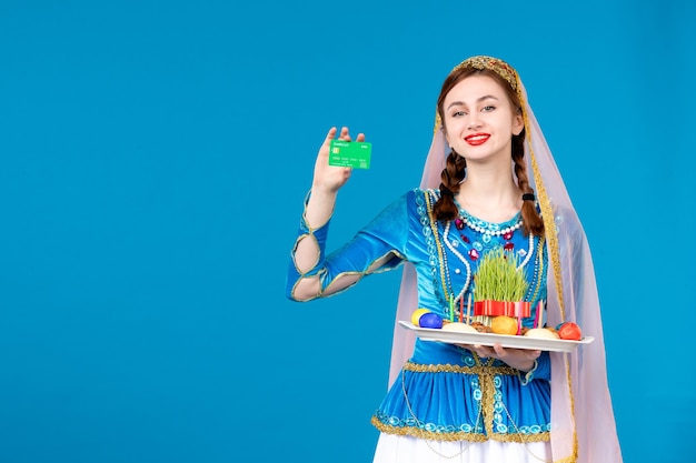 portrait of azeri woman in traditional dress holding xonça and credit card