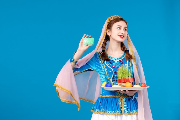 portrait of azeri woman in traditional dress holding xonça and credit card