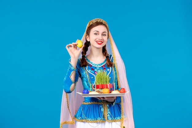 portrait of azeri woman in traditional dress with xonca blue wall ethnic spring