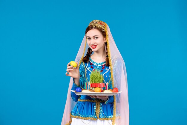 Portrait of azeri woman in traditional dress with xonca blue wall spring novruz ethnic photo