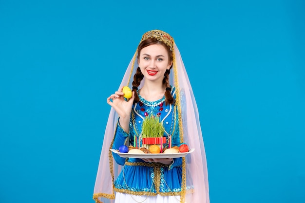 portrait of azeri woman in traditional dress with xonca blue wall spring novruz