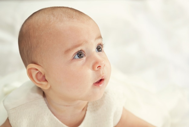 Portrait of a baby in baptismal clothing