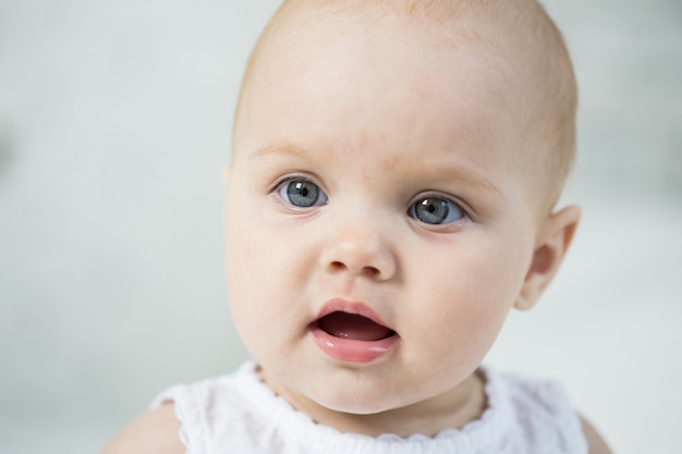 Portrait of a baby on the bed in her room