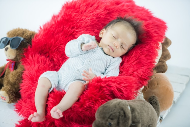 Portrait of a baby on the bed in room