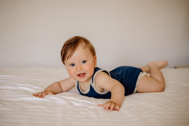 portrait of a baby in bed on a white background