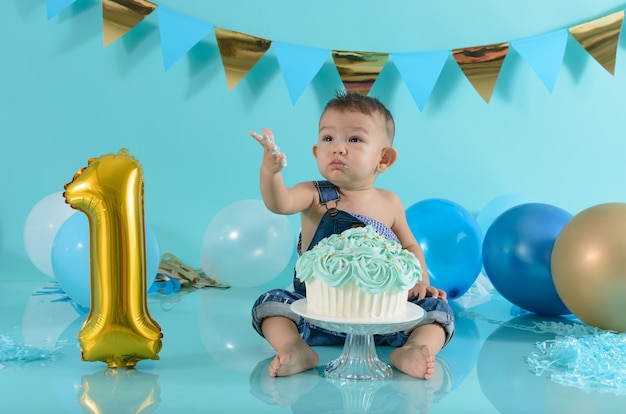 Portrait of baby celebrating his birthday Smash cake session