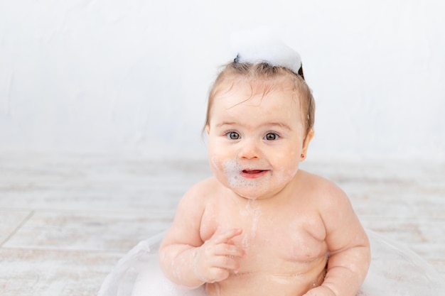 Portrait of a baby in foam bathing and hygiene of the baby