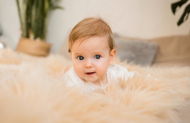 Portrait of a baby girl lying on a fluffy blanket