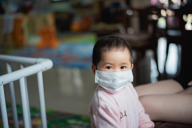 Photo portrait of baby girl wearing mask