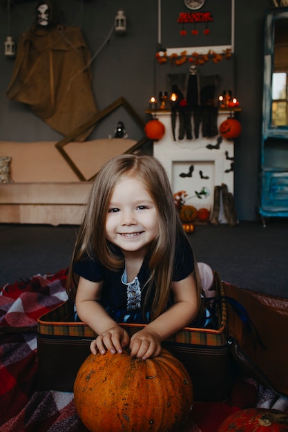 Portrait of a baby in with a pumpkin close-up.