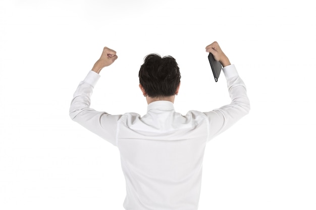 Portrait of back of smart young asian businessman holding computer tablet and Lift up the fist to celebrate on isolated