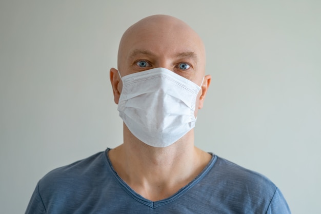 Portrait of a bald man in a medical mask