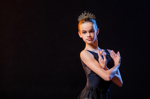 Portrait of a ballerina in a black dress and crown