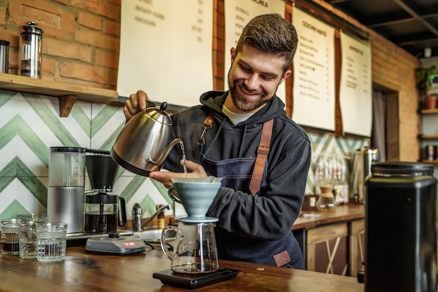 Portrait of barista male making coffee