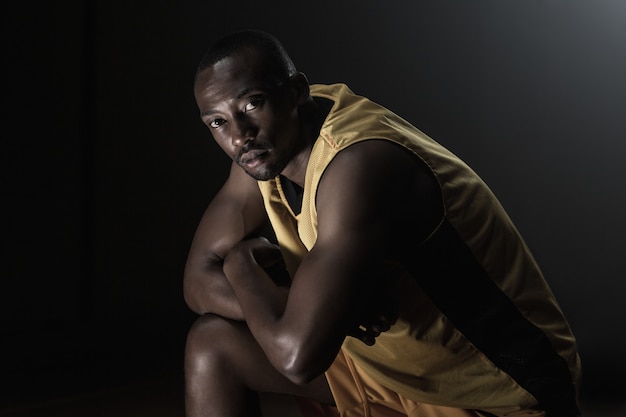 Portrait of basketball player looking and posing with crossed arms