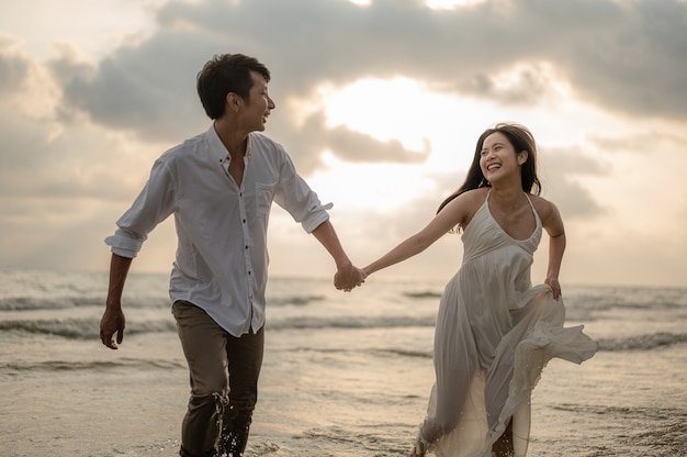 Portrait beach vacation romantic walk couple relaxing on ocean summer travel destination