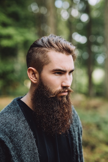 Portrait of a bearded boy in the woods