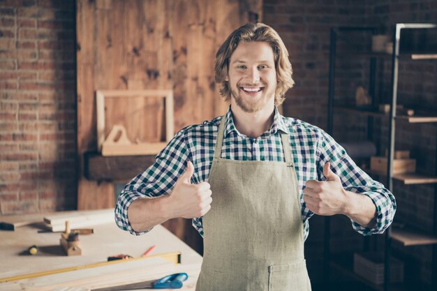 Portrait of bearded craftsman posing in his woodshop