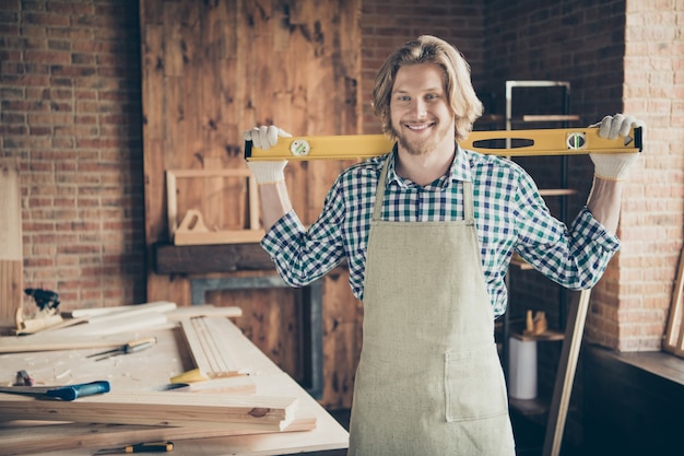 Portrait of bearded craftsman posing in his woodshop