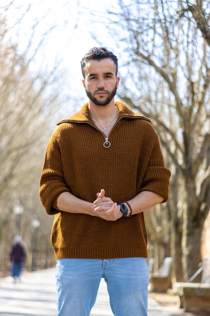 Portrait of bearded handsome man on the street Close up of attractive young man outdoors looking at camera