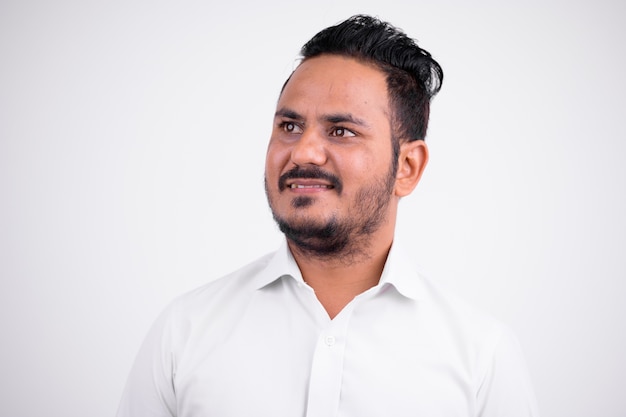 Portrait of bearded Indian businessman on white