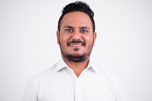 Portrait of bearded Indian businessman on white