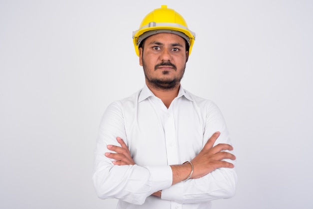 portrait of bearded Indian businessman with hardhat on white