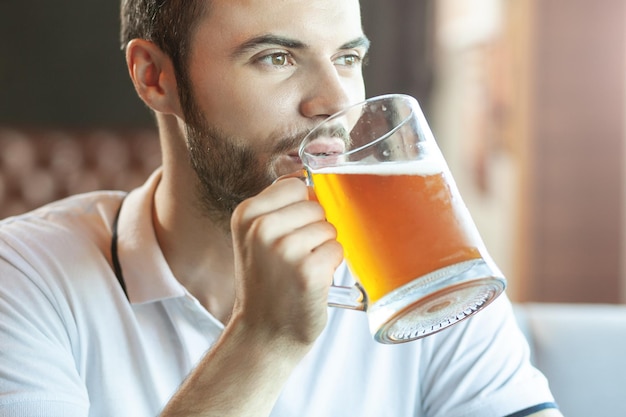 Portrait of bearded man drinking beer