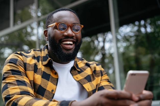 Portrait of a bearded man holding a smartphone