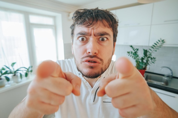 Photo portrait of a bearded man with a wild look conveying craziness and annoyance as he directs his