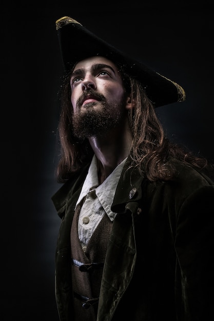 Portrait of a bearded pirate thoughtfully looking up