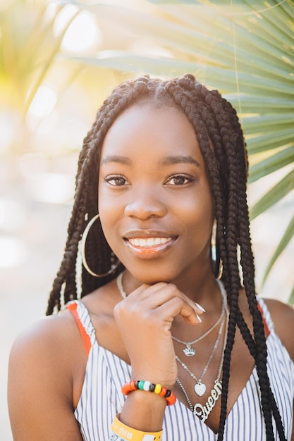 Portrait of beautiful african american woman smiling and looking at the camera during sunset