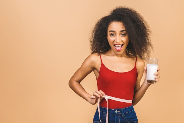 Portrait of beautiful african american woman with glass of milk