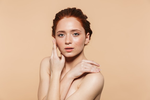 Portrait of beautiful amazing young redhead woman posing isolated.