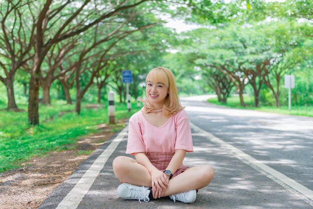 Portrait of beautiful asian girl golden hair with cameraThailand people in pink dresshipster girl